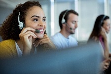 Employee talking to a customer using a phone and headset.